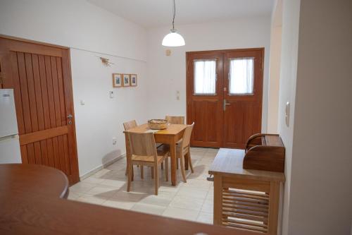 a kitchen and dining room with a table and chairs at Terra Ionian in Áyios Ilías