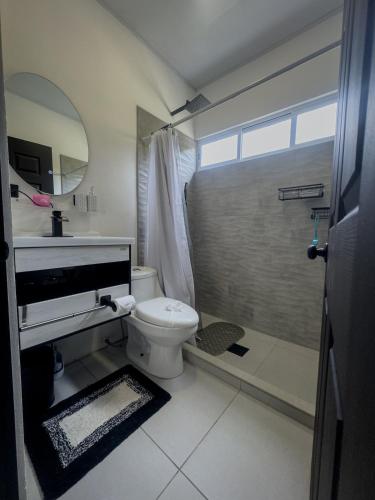 a bathroom with a toilet and a shower at JJ Lux Residential in Jacó