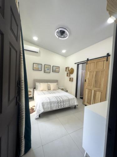 a bedroom with a bed and a open door at JJ Lux Residential in Jacó