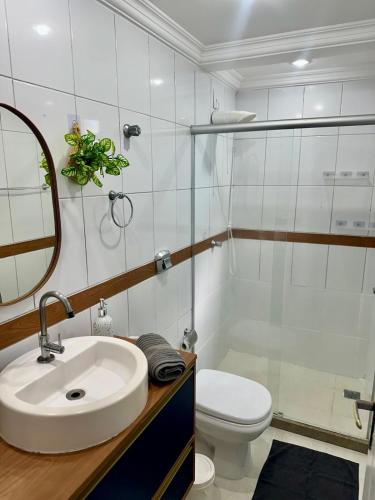 a bathroom with a sink and a toilet and a shower at M901 Vista Mar Ar Cond Garagem in Vila Velha