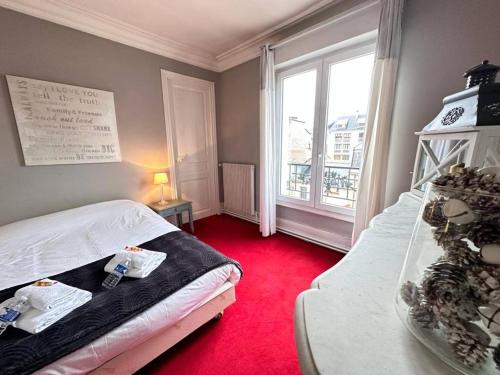 a small room with a bed and a window at Cotta vue sur la cathédrale - 3 chambres 4 lits in Reims