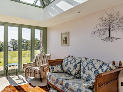 a living room with a couch and a chair at 4 Bed in Wincle 95651 in Allgreave