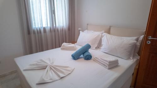 a white bed with white pillows and towels on it at Terra Ionian in Áyios Ilías