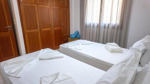 two beds in a room with a mirror at Terra Ionian in Áyios Ilías