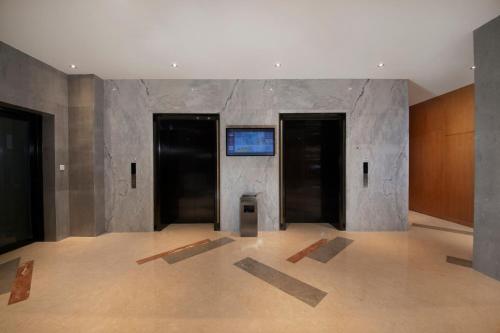 an empty room with a wall with three doors at Holiday Inn Express Zhengzhou Zhengdong by IHG in Zhengzhou
