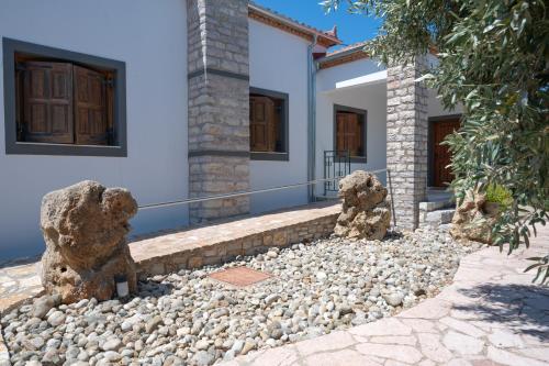 a house with two bear statues in front of it at Terra Ionian in Áyios Ilías