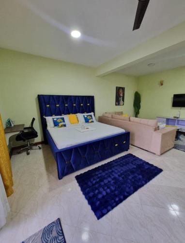 a living room with a bed and a couch at CaLITWAPA APPARTMENTS in Mtwapa