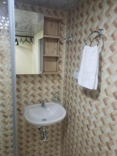 a bathroom with a sink and a mirror at Casa hotel la 33 in Medellín