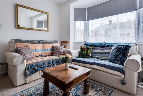 a living room with a couch and a table at Peaceful family home w patio & yard in Oxford