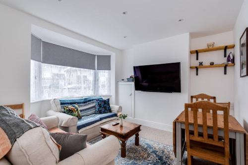 a living room with a couch and a tv at Peaceful family home w patio & yard in Oxford