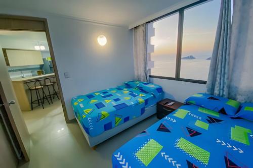 Postel nebo postele na pokoji v ubytování Oasis Marino - Apartamento de 2 Alcobas en El Rodadero