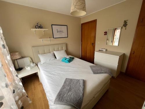 a small bedroom with a bed with a white bedspread at Porto Nest in Senhora da Hora