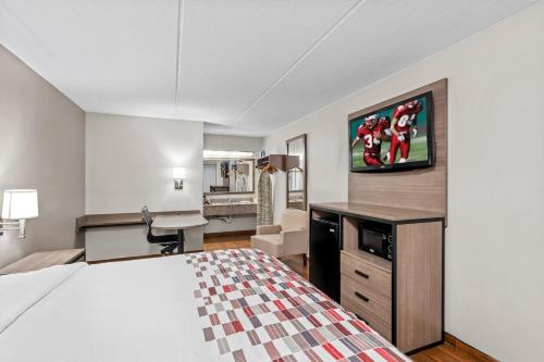 a hotel room with a bed and a desk at Red Roof Inn Jackson Downtown - Fairgrounds in Jackson