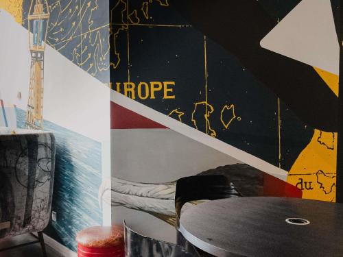a room with a table and a staircase at Mercure Le Havre Centre Bassin Du Commerce in Le Havre