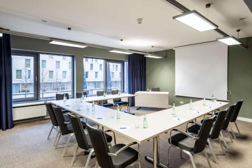 a conference room with a long table and chairs at NH Köln Altstadt in Cologne