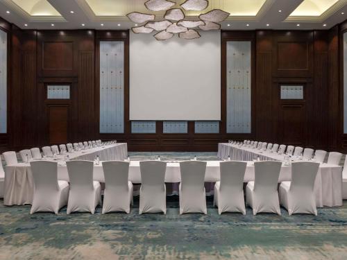a conference room with rows of tables and chairs at Sofitel Cairo Downtown Nile in Cairo