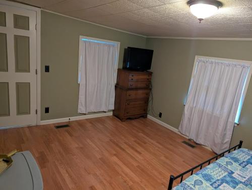 une chambre avec un lit et une télévision sur une commode dans l'établissement Anchor In WaterFront Lake Marion, à Summerton
