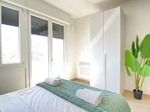 a bedroom with a bed with two towels on it at Suite Emilia 7 in Bologna