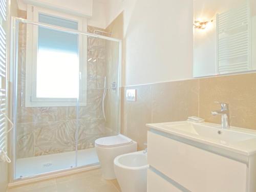 a bathroom with a shower and a toilet and a sink at Suite Emilia 7 in Bologna