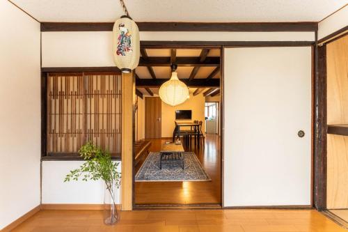a room with a door open to a living room at SkySTAGE十人町 in Nagasaki