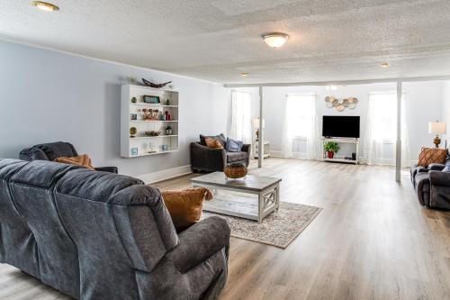 a living room with two couches and a tv at Large Yard and Historic Charm Orangeburg Retreat! in Orangeburg