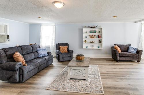 a living room with a couch and two chairs at Large Yard and Historic Charm Orangeburg Retreat! in Orangeburg