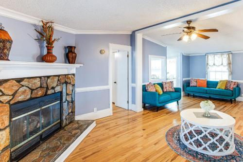 a living room with a fireplace and blue walls at Large Yard and Historic Charm Orangeburg Retreat! in Orangeburg
