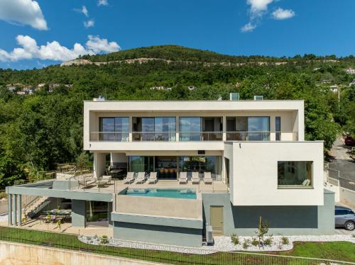 an aerial view of a house with a swimming pool at Villa Ladeti Sereno in Poljane