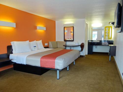 a hotel room with a large bed and a desk at Motel 6-Erie, PA in Erie