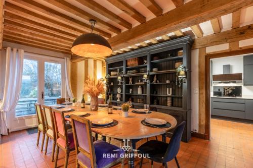 a large dining room with a table and chairs at La Maison de la Corniche Enjoy an Authentic Stay in Normandy - 8 Pax in Barneville-la-Bertran