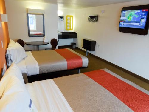 a hotel room with two beds and a flat screen tv at Motel 6-Erie, PA in Erie