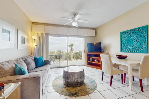 a living room with a couch and a table at Tidewater 105 in Orange Beach