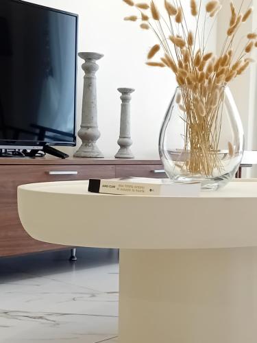 a glass vase on a table with a tv at CENTRAL SPOT AXD in Alexandroupoli