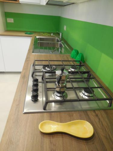 a stove top with a wooden spoon next to it at Villa Cycas in Ischia