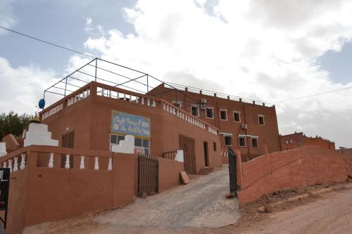 a building with a sign on the top of it at La Belle Vue Guest House in Aït Ben Haddou
