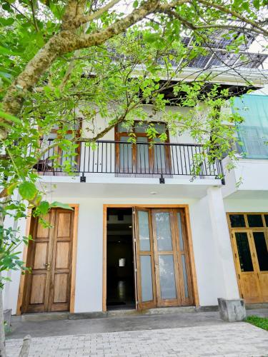 a building with wooden doors and a balcony at Villa Opera House in Galle