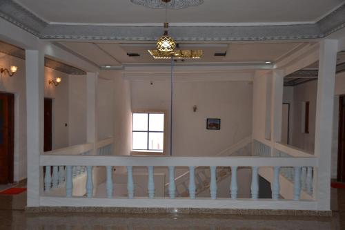 a staircase in a house with a chandelier at La Belle Vue Guest House in Aït Ben Haddou