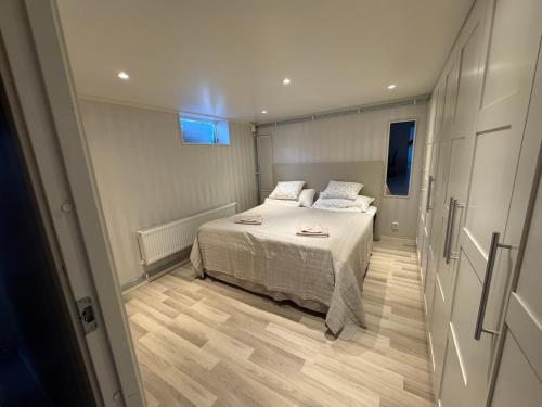 a small bedroom with a bed and a window at Fredholmens Apartment in Gothenburg