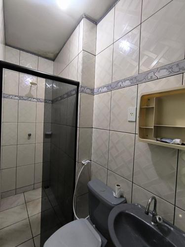 a bathroom with a toilet and a sink at Casa cop 30 in Belém