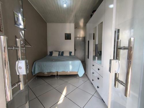 a bedroom with a bed and a shower in it at Casa cop 30 in Belém