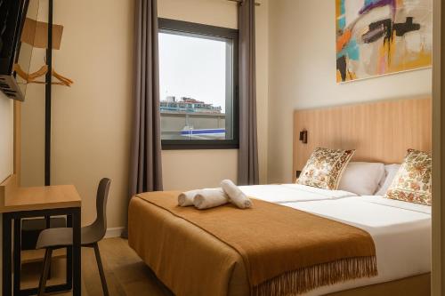a bedroom with a bed and a window at Aerohotel Barcelona Airport 24h in El Prat de Llobregat