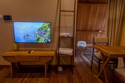 a living room with a flat screen tv on a wall at Wilpattu Safari Resort in Wilpattu
