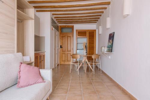 a living room with a couch and a table at Esquerdo 22 by Seaward Suites in Villajoyosa