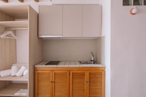 a kitchen with a sink and white cabinets at Esquerdo 22 by Seaward Suites in Villajoyosa