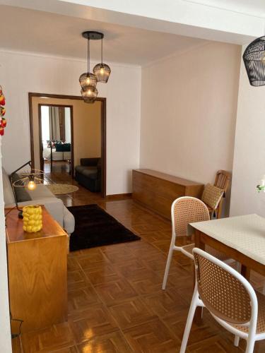 a living room with a couch and a table and chairs at Marina Living in Angra do Heroísmo