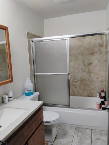 a bathroom with a shower and a toilet and a sink at 1 bedroom in 3 BR condo in Tukwila