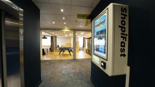 an office with a video game on a wall at ibis Lyon Est Bron in Bron