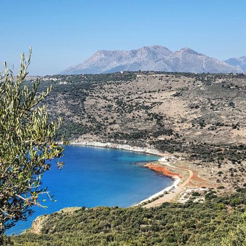 a view of a beach with mountains in the background at Katafigi in Pirgos Dhirou