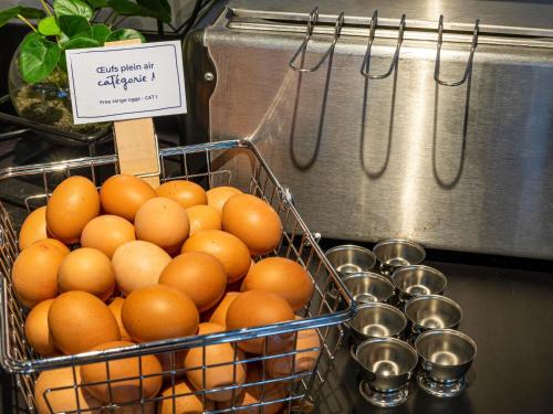 a bunch of oranges in a basket on a counter at ibis Belfort Danjoutin in Belfort