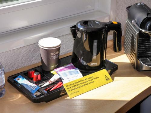 a coffee maker sitting on top of a counter at ibis Bordeaux Lac in Bordeaux